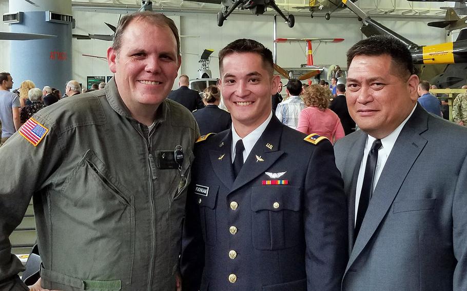 Flight instructor Edward Mitchell stands with Chief Warrant Officer 2 Kirk T. Fuchigami Jr. and his father Kirk T. Fuchigami Sr. in a photo taken at Fort Rucker, Ala.