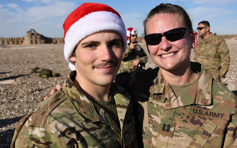Sgt. Teaghen Goida and Capt. Chelsea Statler pose for a photo during a Christmas celebration at a remote base where they were deployed in Syria's Deir El-Zour province on Monday, Dec. 23, 2019. 

