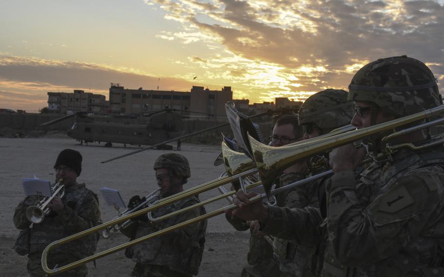 A brass quintet from the 1st Infantry Division's band plays holiday music during a small Christmas celebration at an austere camp in Syria's Hassekeh province on Monday, Dec. 23, 2019. Band members were, from left to right, Spc. Trevor Duell, Chief Warrant Officer 2 Ben McMillan, Sgt. Tristan Calabrese, Spc. Cameron Smith and Sgt. Johnathan Stoby.


