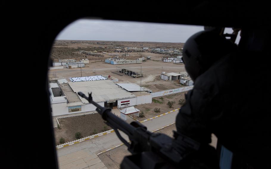 An Iraqi soldier mans a machine gun aboard a helicopter during military operations in Anbar, Iraq, on Dec. 29, 2019. An Iraqi general said security had been beefed up around the Ain al-Asad air base, a sprawling complex in the western Anbar desert that hosts U.S. forces, following a series of attacks. On Saturday, Jan. 4, 2020, the U.S.-led coalition in Iraq suspended training with government security forces following the targeted killing of Iranian Maj. Gen. Qassem Soleimani in Baghdad on Friday. 