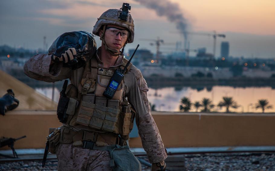 A U.S. Marine with 2nd Battalion, 7th Marines, assigned to the Special Purpose Marine Air-Ground Task Force-Crisis Response-Central Command 19.2, carries a sandbag to strengthen a security post during the reinforcement of the Baghdad Embassy Compound in Iraq on Jan. 4, 2020.