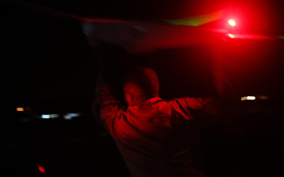 A U.S. service member prepares for the launch of an RQ-20 Puma during night flight operations Sept. 5, 2018, near al-Asad air base, Iraq. The base was attacked early Wednesday, Jan. 8, 2019, by Iran, which launched more than a dozen ballistic missiles at Iraqi bases hosting American troops.