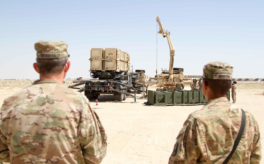 U.S. Army officials watch crews as they practice Patriot Missile Defense System reloading procedures during training in Kuwait on March 25, 2016.