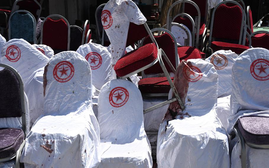 Blood-stained chairs are stacked outside the Dubai City Wedding Hall in Kabul on Aug. 18, 2019, a day after a suicide attack at the venue killed dozens of people.
