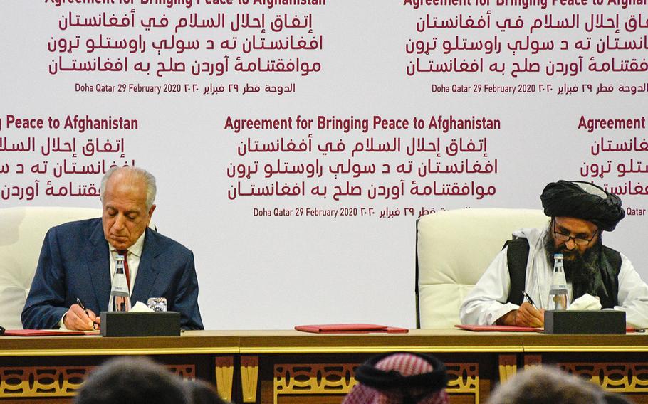 Zalmay Khalilzad, America’s special envoy for Afghan reconciliation, signs a peace deal with the Taliban, along with Mullah Abdul Ghani Baradar, the militant group's top political leader, in Doha, Qatar, on Saturday, Feb. 29, 2020.