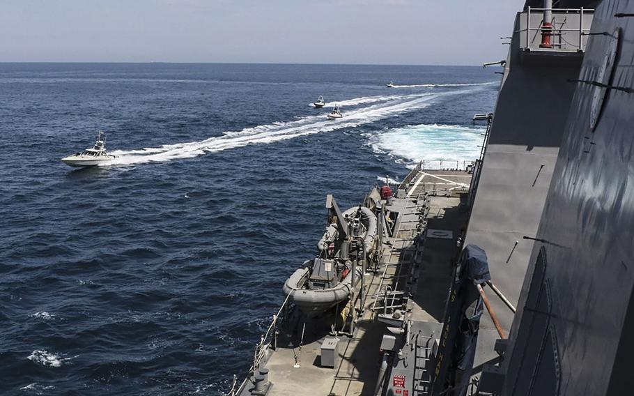 Iranian Islamic Revolutionary Guard Corps Navy (IRGCN) vessels maneuver near U.S. military ships in the Persian Gulf, April 15, 2020.