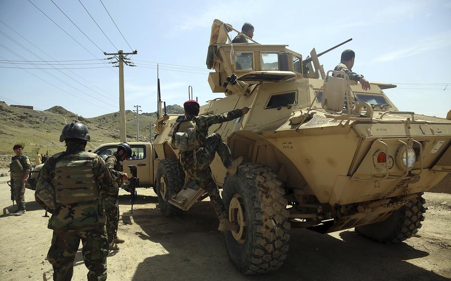 Afghan special forces stand guard at the site of a suicide bomber attack on the outskirts of Kabul, Afghanistan, Wednesday, April 29, 2020. A suicide bomber on Wednesday targeted a base belonging to Afghan special forces on the southern outskirts of the capital, Kabul, officials said.