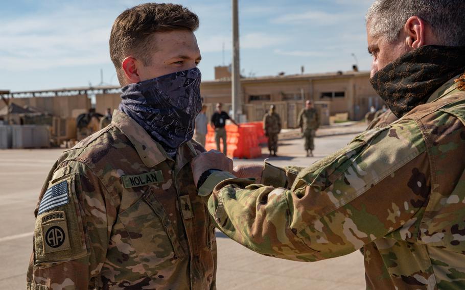 Sgt. Ryan Nolan is presented the Purple Heart medal by 34th Expeditionary Combat Aviation Brigade Commander, Col. Greg Fix, on May 3, 2020, for his injuries sustained during the theater ballistic missile attacks at Al Asad Air Base, Iraq, on January 8, 2020. Sgt. Nolan serves as a Flight Operations Non-commissioned officer with Delta Company, 82nd Aviation Regiment out of Fort Bragg, North Carolina. 