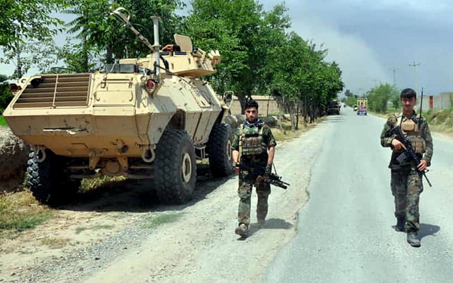 Afghan soldiers patrol a road in northern Kunduz province on Tuesday, May 19, 2020.