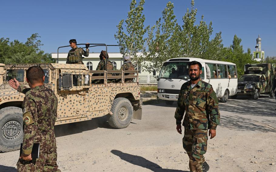 Afghan security forces escort buses of recently freed Taliban soldiers away from Bagram prison on May 26, 2020. The Taliban have demanded 5,000 of their fighters be released before starting peace talks with the government. The country's president said Thursday that they will do so. 

