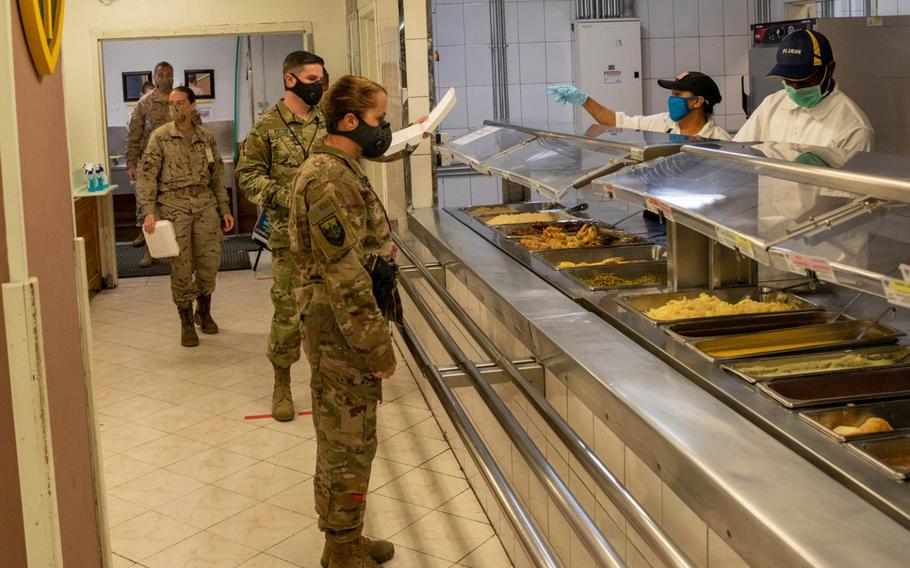 NATO Resolute Support service members and civilians wait for lunch at a dining facility in Kabul, Afghanistan, April 10, 2020.  A defense Department IG report determined that U.S. Forces-Afghanistan did not seek full reimbursement for dining facility services provided to coalition partners at the facility during the January 2016 to September 2019 time period.