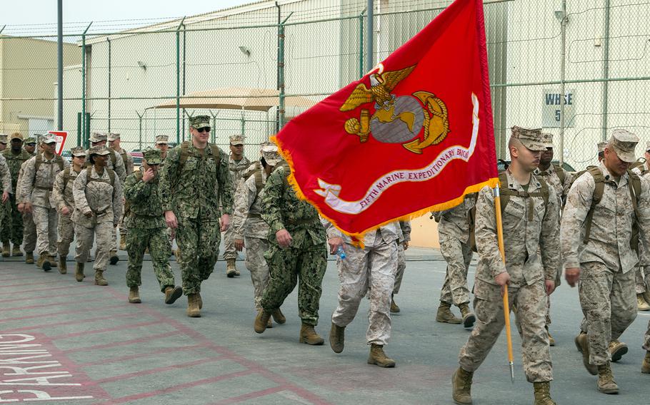 Members of Naval Amphibious Force, Task Force 51/5th Marine Expeditionary Brigade participate in a three mile all-hands hike in Bahrain, March 21, 2019. 