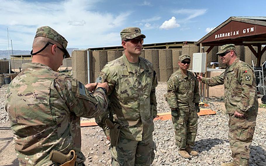 Capt. Matthew Dixon, who deployed with the 1st Battalion, 87th Infantry of the 10th Mountain Division, receives a combat patch during his deployment to Afghanistan during the spring of 2020. Dixon's deployment was cut short after the U.S. agreed to withdraw troops from the country under a deal signed with the Taliban in February. 
