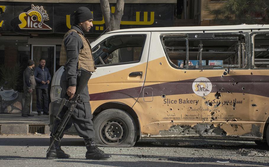 An Afghan security official patrols a section of road in the Shar-e-Now area of Kabul, which was hit by rockets on Saturday, Nov. 21, 2020.
