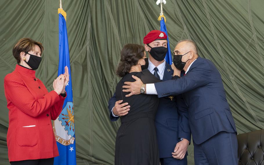 Staff Sgt. Alaxey Germanovich, 26th Special Tactics Squadron combat controller, hugs his mother and father after being awarded the Air Force Cross, Dec. 10, 2020, at Cannon Air Force Base, N.M. Barbara Barrett, Secretary of the Air Force, presented the medal to Germanovich for his actions during a fierce firefight in Nangarhar Province, Afghanistan, April 8, 2017. 