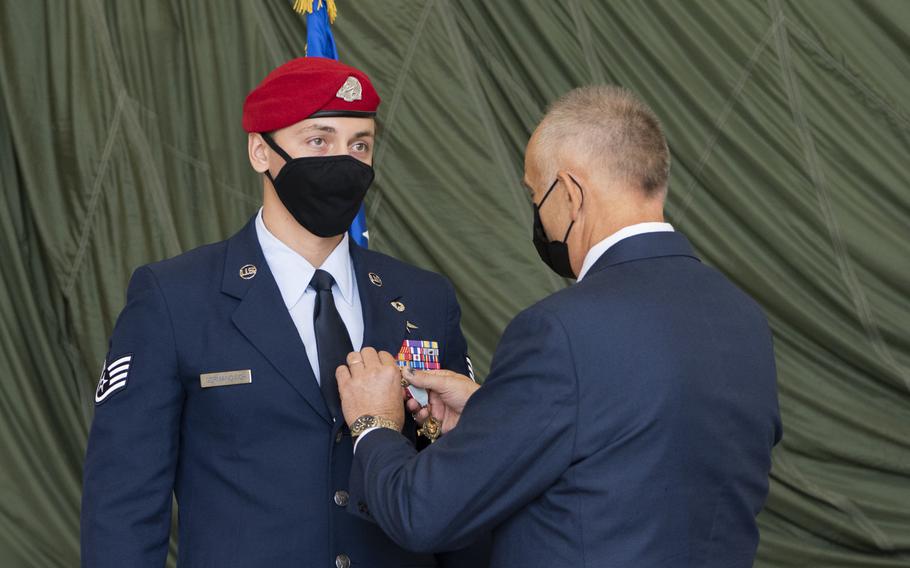 The father of Staff Sgt. Alaxey Germanovich, 26th Special Tactics Squadron combat controller, pins the Air Force Cross medal on his son, Dec. 10, 2020, at Cannon Air Force Base, N.M. 

