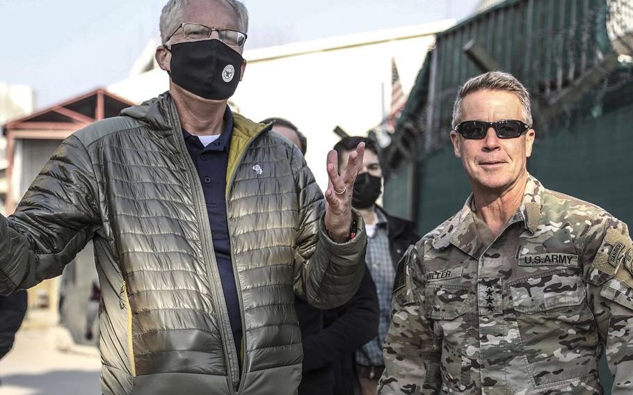 Acting Defense Secretary Christopher Miller speaks with Army Gen. Scott Miller, commander of Resolute Support, at the command's headquarters in Kabul Dec. 22, 2020. Miller visited Afghanistan to discuss the ongoing support for the country's security as well as learn more about the drawdown efforts of troops.