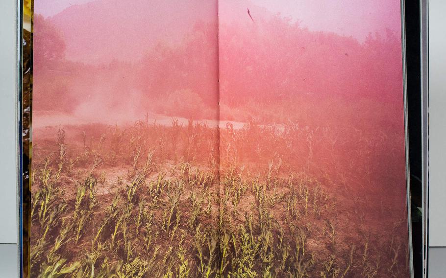 Smoke obscures a field in "Attention Servicemember," by U.S. Army war veteran Ben Brody, a book that attempts to convey the experience of the Iraq and Afghanistan Wars via photography. 
