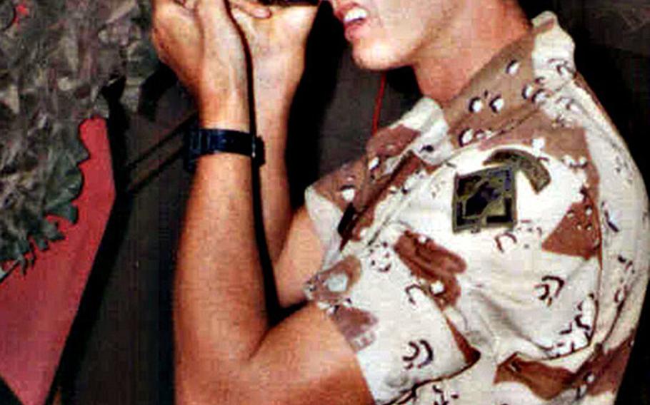 Sgt. Kirby Lee Vaughn, of Bravo Company, 27th Engineer Battalion, 20th Engineer Brigade, XVIII Airborne Corps, takes photos during Operation Desert Shield in Saudi Arabia in 1990.

