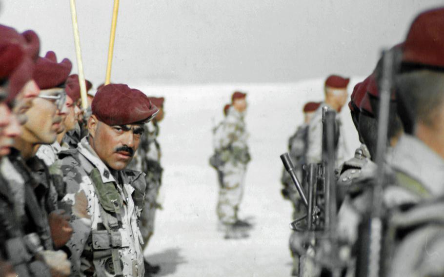 Looking at the photographer, 1st Sgt. Fred Ferryerra stands in formation during a ceremony on Christmas Day 1990.

