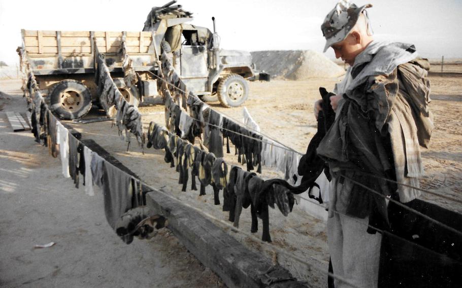 A soldier takes down laundry during Operation Desert Storm in January 1991.

