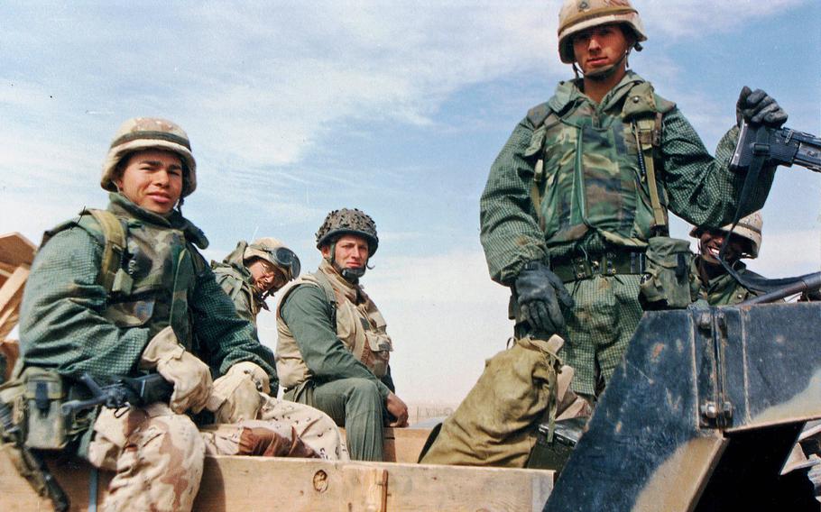 A group of U.S. soldiers pose during Operation Desert Storm in 1991.

