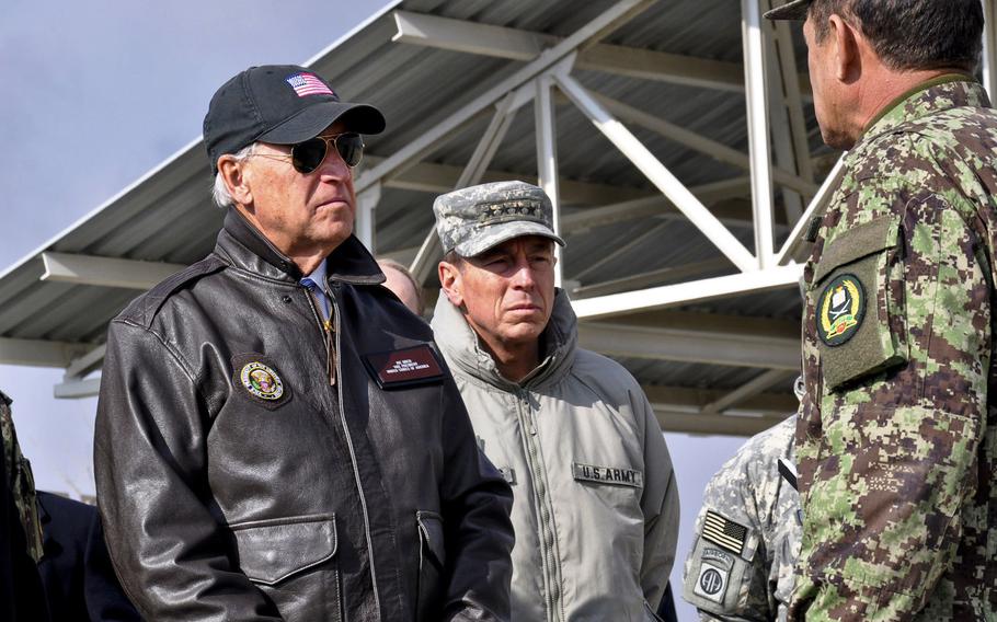 In a 2011 visit to Afghanistan, then-Vice President Joe Biden listens to Afghan Brig. Gen. Amlaqullah Patyani, commander of Kabul Military Training Center. In the center is Gen. David Petraeus, then the commander of the International Security Force. As president, Biden must determine whether to soon withdraw all U.S. troops from Afghanistan.   

