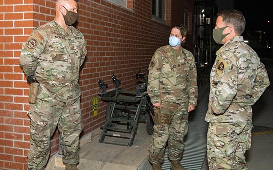 Air Force Master Sgt. Brandon Hockenbarger, left, briefs Gen. Scott Miller, commanding general of U.S. and coalition forces in Afghanistan, on efforts to combat a coronavirus outbreak at NATO Resolute Support Headquarters in Kabul, Afghanistan, sometime in 2020. In the center is Capt. Katie Coble. Hockenbarger, Coble and Capt. Kathleen Schurr were all awarded the Bronze Star for helping stem a coronavirus outbreak at the base.