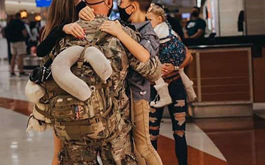 Air Force Master Sgt. Brandon Hockenbarger reunites with his wife and three children on Nov. 5, 2020, after a deployment fighting a coronavirus outbreak at NATO Resolute Support Headquarters in Kabul, Afghanistan.

