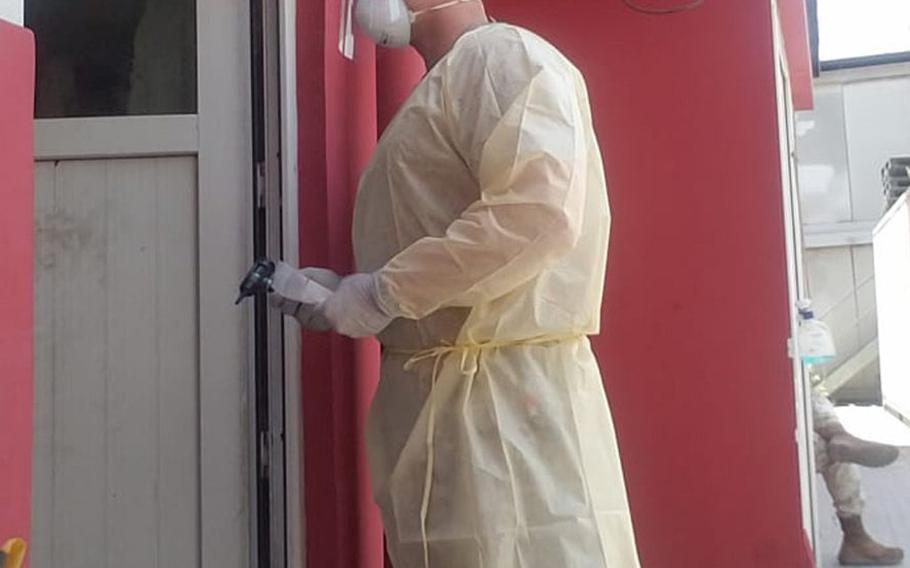 Air Force Master Sgt. Brandon Hockenbarger conducts door-to-door coronavirus testing for those in isolation at NATO Resolute Support Headquarters in Kabul, Afghanistan, sometime in 2020. 
