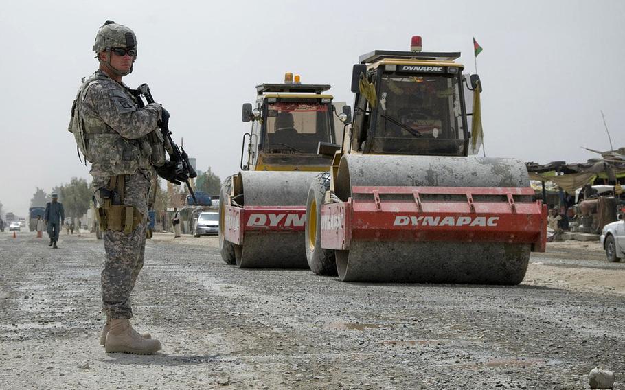Sgt. Randy Elmore, 525th Battlefield Surveillance Brigade, secures a reconstruction project along Highway 4 in Spin Boldak, Afghanistan, in 2011. The construction was funded through the Commander's Emergency Response Program. Lawmakers have directed the military to stop the multibillion-dollar program.