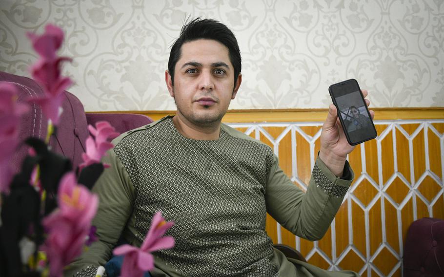 Bashir Ahmad Vesa mourns the death of his brother, Massoud Atal, an Afghan pilot shot by gunmen in Kabul, Afghanistan on Dec. 30, 2020. Vesa keeps photos of his younger brother to keep his memory alive, he said on Jan. 21, 2021.