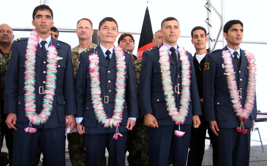 Mohammed Naiem Asadi, first row, second from left,  graduates flight school Jan. 27, 2013 after receiving training from American instructors. Asadi, now an Afghan air force major, has reapplied for refuge in the United States while in hiding.

