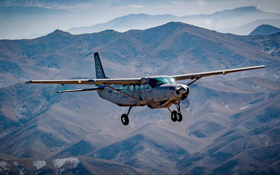 An Afghan pilot trains in a C-208 Caravan over Kabul, Afghanistan in 2018. Most U.S. advisers to the Afghan air force have left, which has paralyzed the mission to train and maintain pilots and air crews, a recent report to Congress said.

