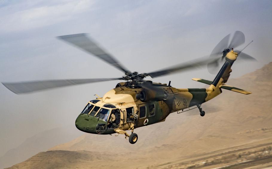 An Afghan air force UH-60 Black Hawk flown by Afghan and U.S. pilots flies over Afghanistan in 2018. Most U.S. advisers to the Afghan air force have left, which has paralyzed the mission to train and maintain pilots and air crews, a recent report to Congress said.


