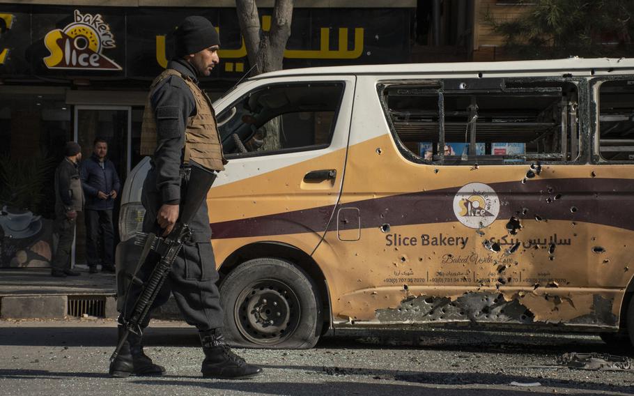 An Afghan security official patrols a section of road in the Shar-e-Now area of Kabul, which was hit by rockets on Saturday, Nov. 21, 2020. The final months of 2020 saw a spike in the number of civilians killed and injured in Afghanistan, but the overall number of casualties last year fell to a seven-year low, the United Nations said Tuesday. 
