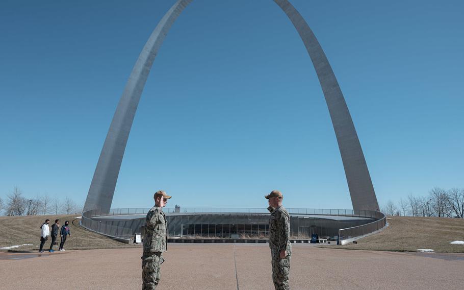 Navy Counselor 1st Class Dalton Kotz, right, a recruiter assigned to Navy Talent Acquisition Group (NTAG) Mid America, reenlists in front of the Gateway Arch, Feb. 23, 2021.

