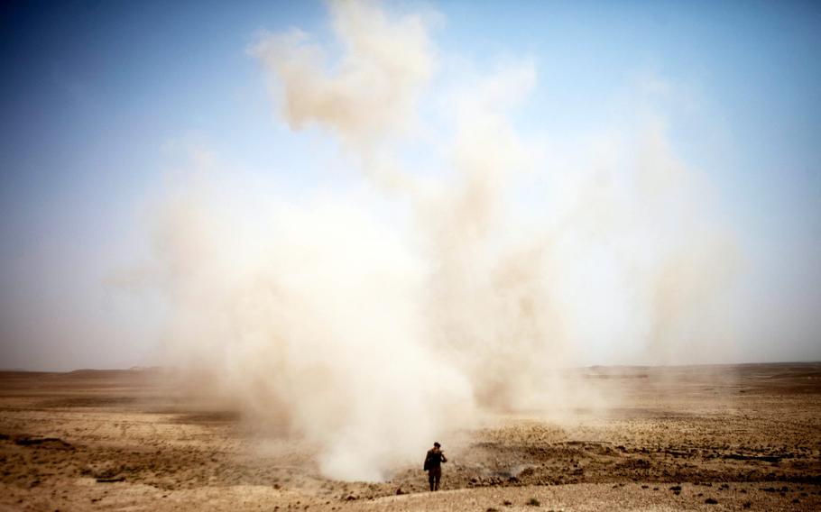 Marine Corps Sgt. Danny Ridgeway, with Regimental Combat Team 8, conducts a post-blast assessment shortly after the detonation of an explosives cache found in Sangin, Afghanistan, in 2011.  Even small explosions may change the molecular structure of the brain and increase the risk of Alzheimer’s disease, Army-funded researchers said in a paper published by the journal Brain Pathology, Feb. 25, 2021.
