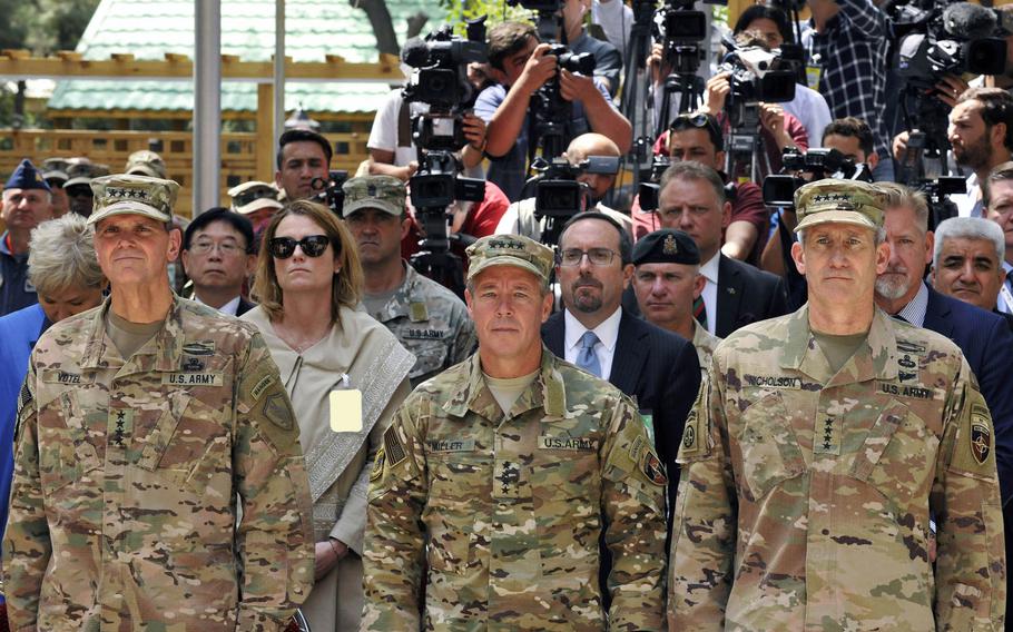 Gen. Joseph Votel, United States Central Command commander, Gen. Scott Miller, Resolute Support mission commander, and Gen. John Nicholson, outgoing Resolute Support mission commander, stand for the playing of the NATO Hymn during the change-of-command ceremony in Kabul, Afghanistan, Sept. 2, 2018. Miller became the  longest-serving commander of American and NATO forces in Afghanistan on Friday, March 5, 2021.
