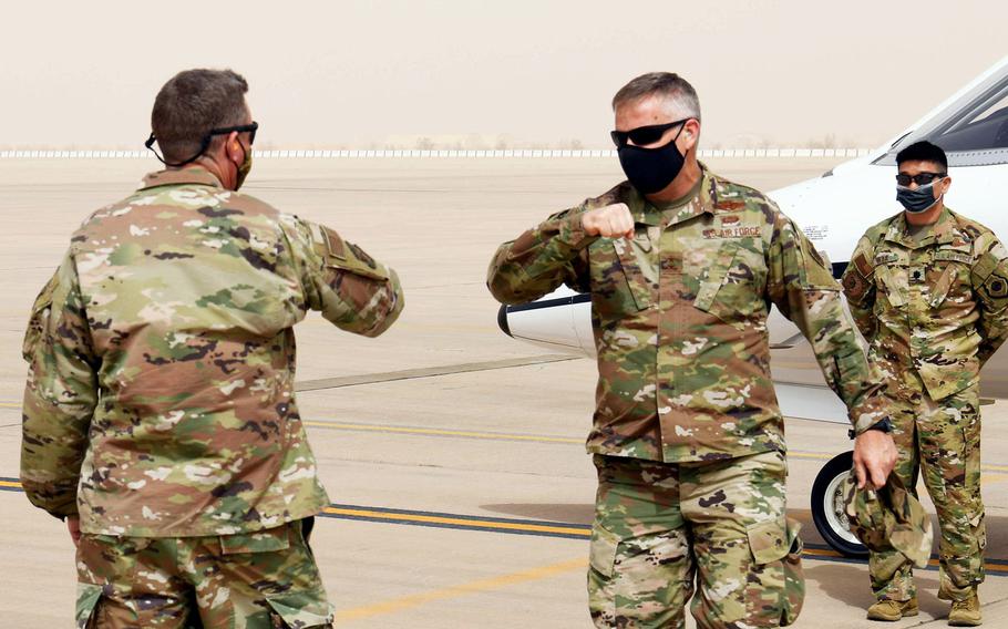 Maj. Gen. Michael Koscheski, U.S. Air Forces Central deputy commander, gets ready to elbow-bump Brig. Gen. Evan Pettus, 378th Air Expeditionary Wing commander, as he arrives at Prince Sultan Air Base, Saudi Arabia, March 5, 2021. Military officials are urging continued vigilance against the coronavirus after a doctor said there was an uptick in infections in the region last month.
