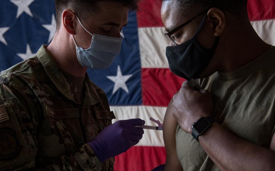 A medical airman at Al Udeid Air Base, Qatar administers a coronavirus vaccine in an undated photo. U.S. Central Command has shipped both the Moderna and Johnson & Johnson vaccines to the Middle East and expects 26,000 more Johnson & Johnson doses by the end of March, officials said. 



