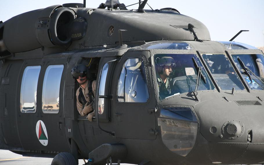 An Afghan pilot trains with American contractors on a UH-60 Black Hawk at Kandahar Airfield in November 2017. A recent Twitter post by Jack McCain, who served as a military adviser in Afghanistan, led to better medical care for one of his former student pilots following a combat injury.

