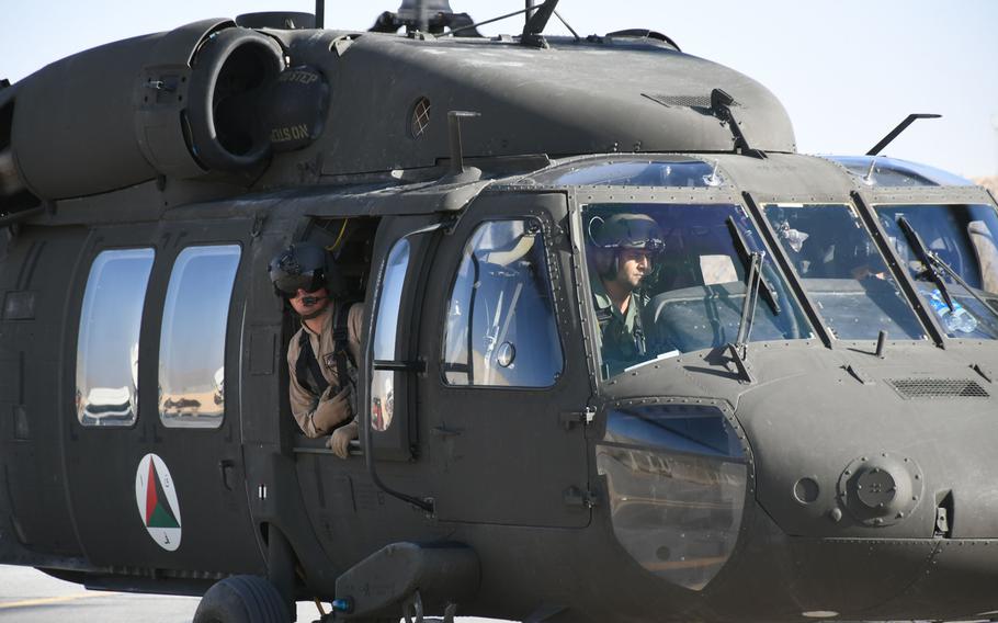 An Afghan pilot trains with American contractors on a UH-60 Black Hawk at Kandahar Airfield in November 2017. A recent Twitter post by Jack McCain, who served as a military adviser in Afghanistan, led to better medical care for one of his former student pilots following a combat injury.