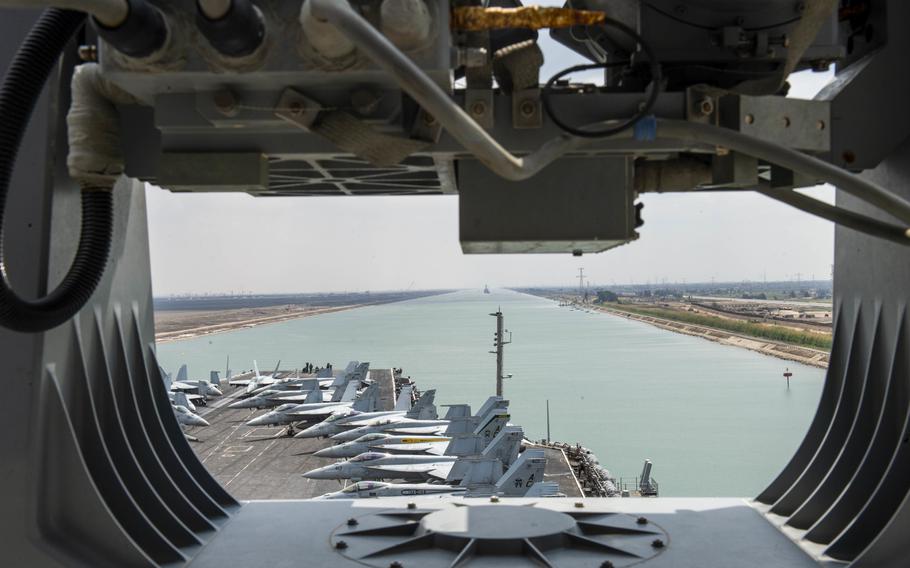 The aircraft carrier USS Dwight D. Eisenhower transits the Suez Canal, April 2, 2021. The canal was blocked for six days when a commercial ship ran aground last month.  
