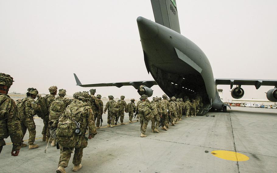 In a March, 2012 photo, soldiers with 3rd Brigade Combat Team, 10th Mountain Division load on to an Air Force C-17 on March 3 at Kandahar Air Field for their return home to Fort Drum, N.Y., after a year in Afghanistan.