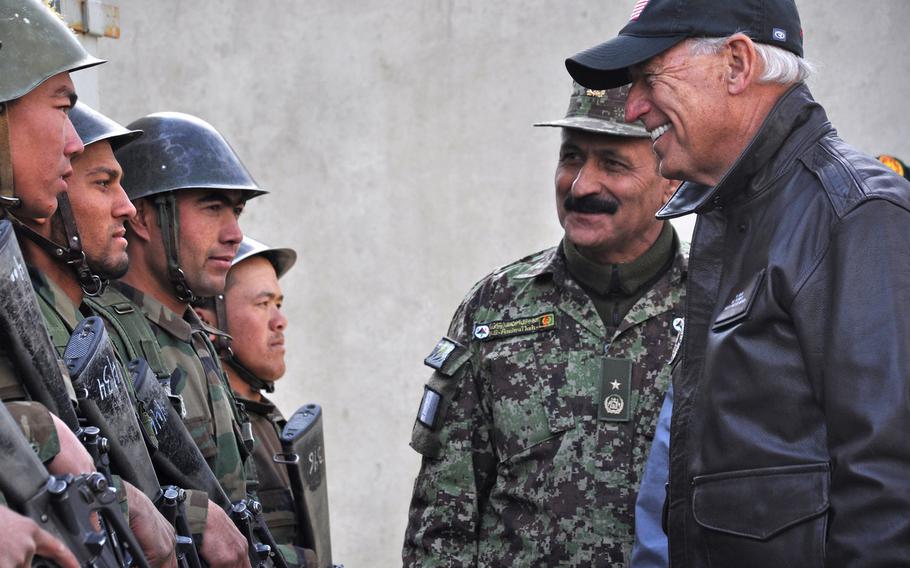 In November 2011, Afghan National Army Brig. Gen. Amlaqullah Patyani introduces then-Vice President Joe Biden to Afghan recruits in Kabul. The Biden administration plans to withdraw all U.S. forces from Afghanistan by Sept. 11, 2021.

