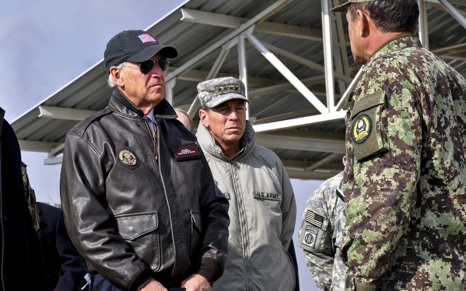 Afghan national army Brig. Gen. Amlaqullah Patyani briefs then-Vice President Joe Biden and International Security Force commander Gen. David Petraeus on activities at a Kabul troop training facility in 2011. The Biden administration plans to withdraw all U.S. forces from Afghanistan by Sept. 11, 2021. 

