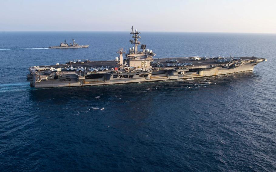 USS Dwight D. Eisenhower (CVN 69) in the foreground operates in the Arabian Sea on April 19, 2021.