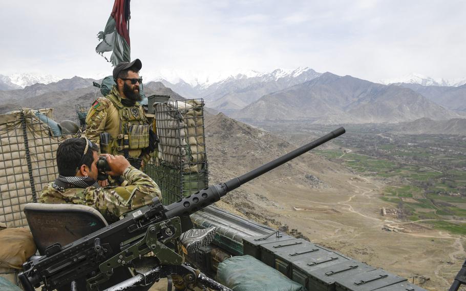 Afghan commandos watch as mortar shells pound Taliban positions March 10, 2021, in Kapisa, a province northeast of Kabul, Afghanistan. Attacks on Afghan troops and police by militant groups and insider attacks were up sharply in the first three months of 2021, the Special Inspector General for Afghanistan Reconstruction said in a report.