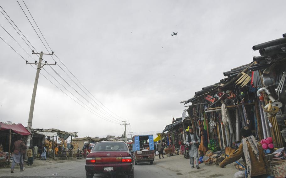 An American transport plane takes off over the city surrounding Bagram Airfield on March 6, 2021. The formal beginning of the U.S. withdrawal from Afghanistan began May 1, 2021.
